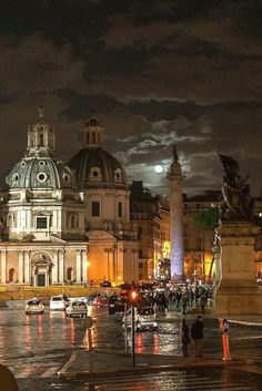 a city street at night with cars and people