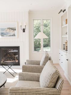 a living room filled with furniture and a fire place