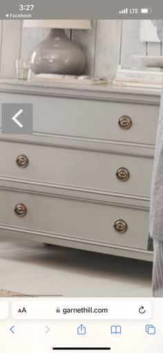 an image of a dresser with drawers on the top and bottom, in front of a mirror