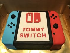 a cake that has been made to look like video game controllers with the words tommy switch on it