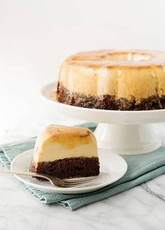 a cheesecake on a plate with a fork next to it and another cake in the background