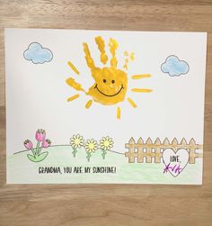 a handprinted card with the words grandma you are my sunshine and a drawing of a smiling sun