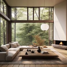 a living room filled with furniture and a fire place in front of a large window