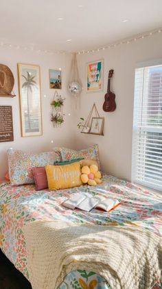 a bed room with a neatly made bed and lots of pictures on the wall above it