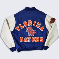 Florida Gators Vintage 80s Chalk Line Varsity Bomber Jacket  University College Blue and Orange Coat Made in USA Stitched On Logos & Letters In Excellent Vintage Condition No Holes or Stains Size Men's : Small ( S ) Please Check Your Measurements Measurements: Length: 24 in Pit to pit: 23 in FREE AND FAST SHIPPING IN THE USA Fitted Retro Cotton Varsity Jacket, Collegiate Long Sleeve Sport Coat For Fall, Collegiate Blue Varsity Jacket For Fall, Collegiate Navy Outerwear For Fall, Throwback College Track Jacket For Fall, Collegiate Style Navy Outerwear For Fall, Throwback Fall Track Jacket For College, College Throwback Track Jacket For Fall, Blue Retro Outerwear For Sports Events