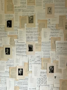 many pieces of paper have been pinned to the wall with old sheet music notes on them