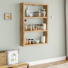 a wooden shelf with spices and condiments on it in the corner of a room