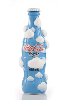 a blue coca cola bottle with white clouds on it