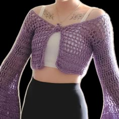 a close up of a person wearing a purple knitted sweater and black skirt with white top