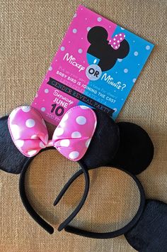 a minnie mouse headband with a pink and white polka dot bow is next to a book