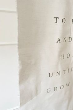 a close up of a piece of cloth with words on it that say to him and her, hold until he grows