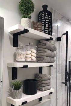 bathroom shelves with towels and plants on them