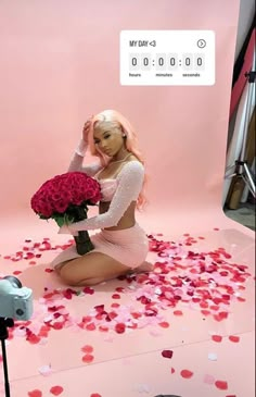 a woman kneeling down with flowers in front of her