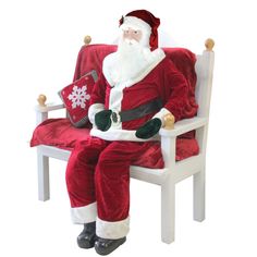 a santa claus sitting on a white chair