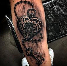 a tattoo with a heart and key on it