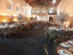 a large banquet hall with tables and chairs set up for formal function or wedding reception