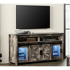 an entertainment center with a flat screen tv mounted on the wall