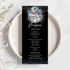 a black and white menu card with a disco ball on it, surrounded by silver confetti