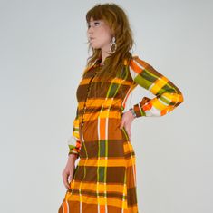 "Stunning 1970's plaid maxi dress! Made in a bold Autumn toned plaid pattern. Made in a super soft cotton material. The cotton has a pretty sheen to it, much like a polished cotton. Pointed collar, button down bodice / collar. Balloon sleeves with buttons at cuffs. Unlined. ♥♥ Fits Like: XS - Small TAG: -- BRAND: -- Excellent Vintage Condition: ♥ MEASUREMENTS; Bust: 33\" Waist: 31\" Hips: 40\" Length: 54.5\" Shoulder seam to seam: 14\" Underarm seam: 18.5\" Measurements of Model: Bust: 35\" Wais Retro Plaid Mini Dress, Fitted Retro Plaid Dress For Fall, Retro Fitted Maxi Dress For Fall, Retro Maxi Dress For Fall, Plaid Maxi Dress, Of Model, Vintage Store, Balloon Sleeves, Plaid Pattern