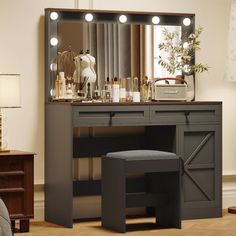 a dressing table with lights on it and a stool