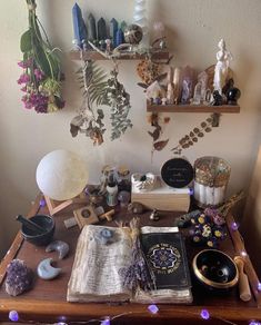 an open book sitting on top of a wooden table next to other items and decorations