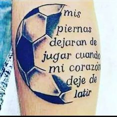 a man with a tattoo on his leg that has a soccer ball in the middle