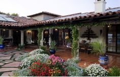 an outdoor patio with potted plants and flowers