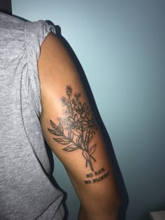 a woman's arm with a flower tattoo on the left side of her arm