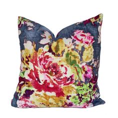 a colorful floral pillow on a white background