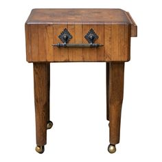 an old wooden table with two drawers on one side and brass knobs on the other