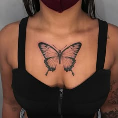 a woman's chest with a butterfly tattoo on her left side, and a black choker