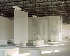 an empty room with white columns in it