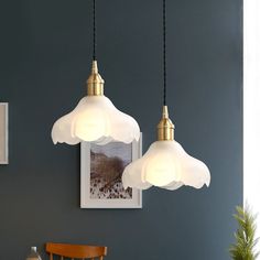 three lights hanging from a ceiling in a dining room