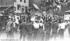 an old black and white photo of people standing in front of a house