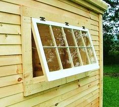 a window on the side of a wooden building