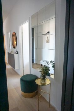 an instagram photo of a living room with a green ottoman and gold side table