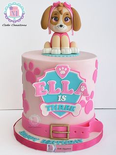 a birthday cake with a dog on top