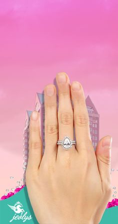 a woman's hand with a diamond ring on her finger, in front of a pink background