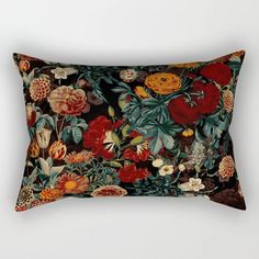 a rectangular pillow with an image of flowers and leaves on the front in red, orange, green, yellow and brown colors