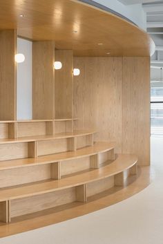 an empty room with wooden steps and shelves