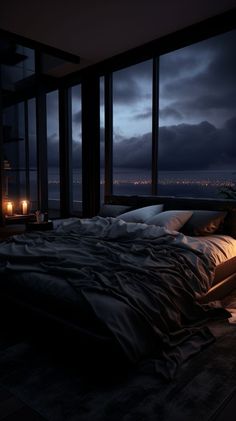 a large bed sitting next to a window in a bedroom under a night sky filled with lights