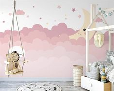 a child's bedroom with pink walls and stars on the wall, a teddy bear swing