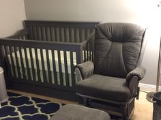 a baby's room with a rocking chair, crib and footstool