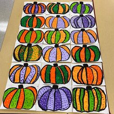 a group of painted pumpkins sitting on top of a table