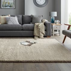 a living room filled with furniture and a clock on the wall