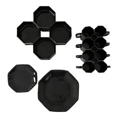 black plates and cups are arranged on a white background