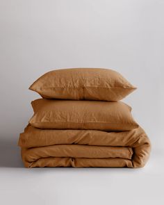 three brown pillows stacked on top of each other