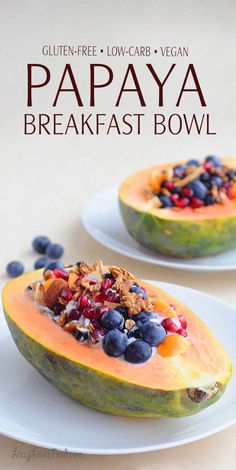 papaya breakfast bowl with blueberries and granola in it on a white plate