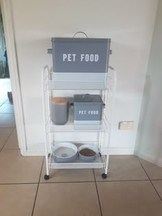 a pet food cart with two bowls and one bowl on the bottom shelf next to it