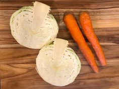 carrots and cabbage on a wooden cutting board